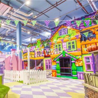 Colourful play houses at Fun Street with colourful bunting and picket fences