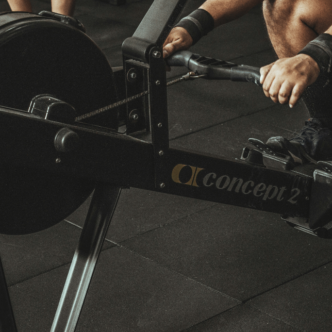 A man using a rowing machine in a gym