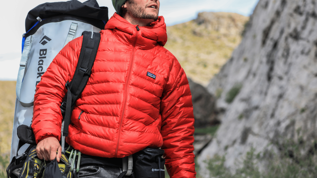 A man wearing a Patagonia jacket hiking.